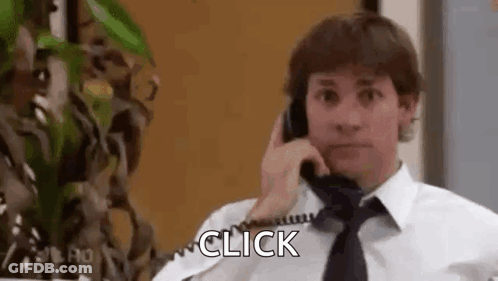 A Man In A Tie Is Talking On A Telephone . GIF