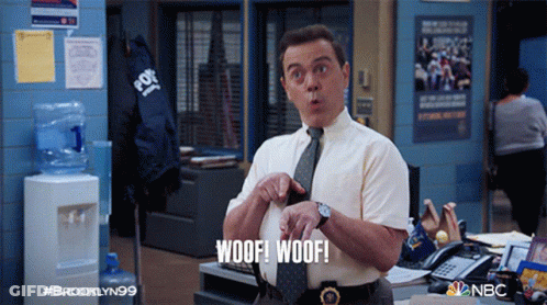 A Man In A Tie Says Woof Woof In An Office GIF