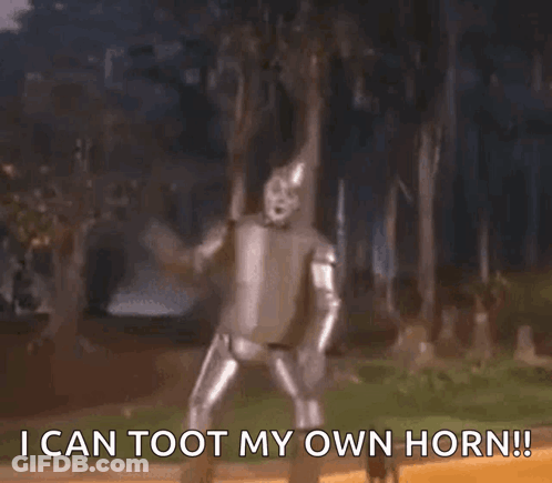 A Man In A Tin Man Costume Says " I Can Toot My Own Horn !! " GIF