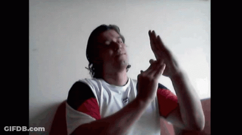 A Man In A Tommy Hilfiger Shirt Is Making A Funny Face GIF