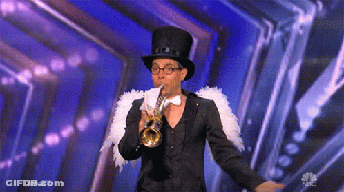 A Man In A Top Hat And Bow Tie Is Playing A Trumpet On A Stage Sponsored By Nbc GIF