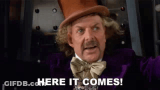 A Man In A Top Hat And Bow Tie Is Saying Here It Comes ! GIF