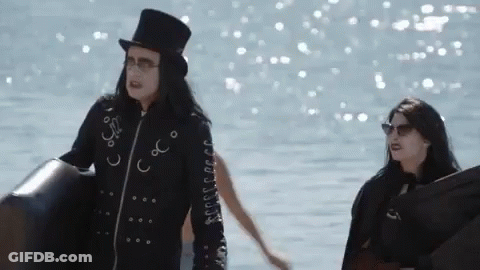A Man In A Top Hat Holding A Beach Ball GIF