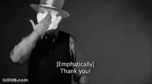 A Man In A Top Hat Is Covering His Mouth With His Hand And Says `` Thank You '' . GIF