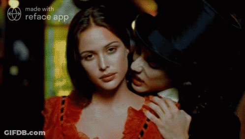 A Man In A Top Hat Is Holding A Woman In A Red Dress GIF