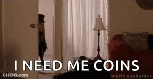 A Man In A Top Hat Is Standing In A Living Room With The Words `` I Need Me Coins '' Written On It . GIF