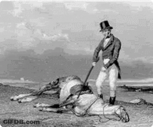 A Man In A Top Hat Is Standing Next To A Dead Horse In A Field . GIF
