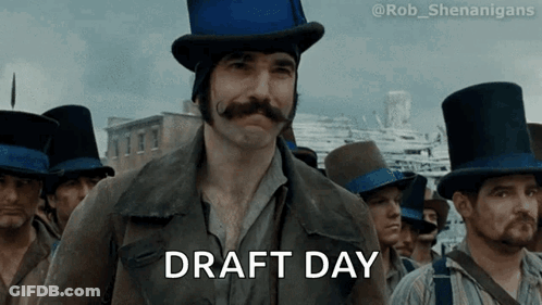 A Man In A Top Hat Says Draft Day In Front Of A Crowd GIF