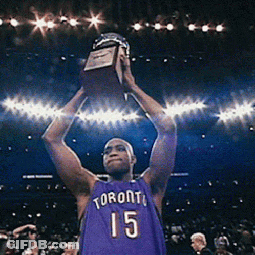 A Man In A Toronto Jersey Holds A Trophy In His Hands GIF