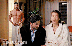 Man In Towel Behind Woman And Shirtless Man GIF