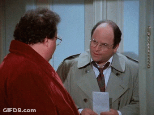 A Man In A Trench Coat And Tie Is Holding A Piece Of Paper And Talking To Another Man In A Red Robe . GIF
