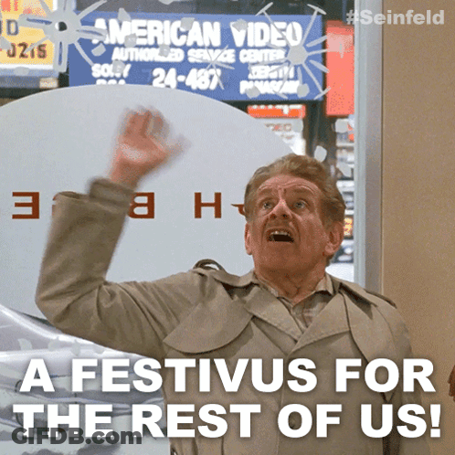 A Man In A Trench Coat Is Standing In Front Of A Sign That Says American Video GIF