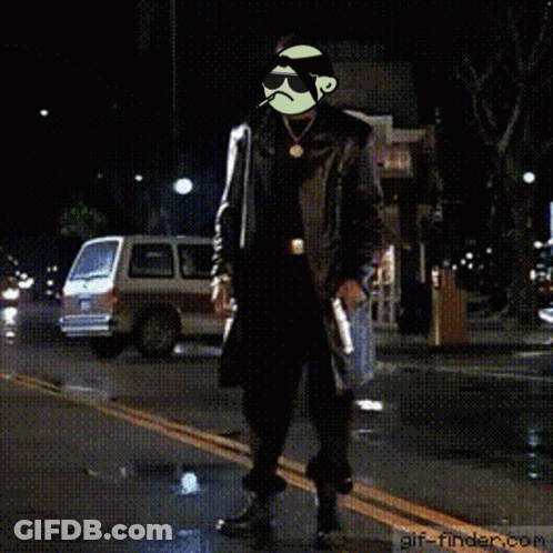 A Man In A Trench Coat Is Standing On A Street With A Gif-Finder.com Logo In The Corner GIF