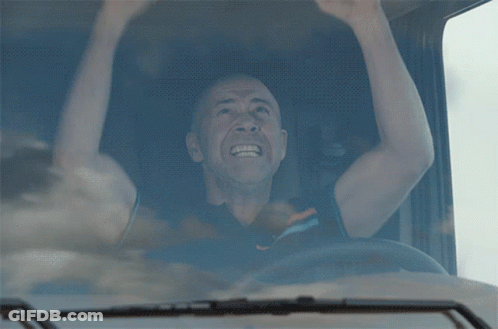 A Man In A Truck With His Arms In The Air And The Word Tg On The Bottom GIF