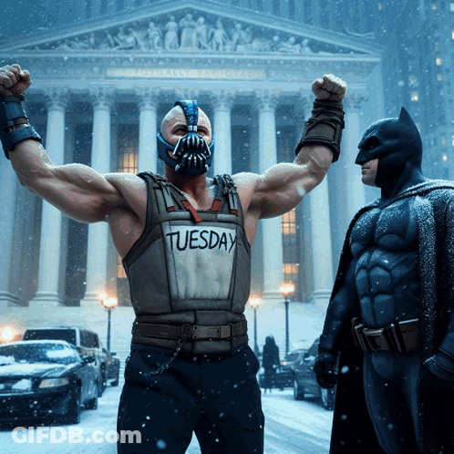 A Man In A Tuesday Vest Is Standing Next To A Batman GIF