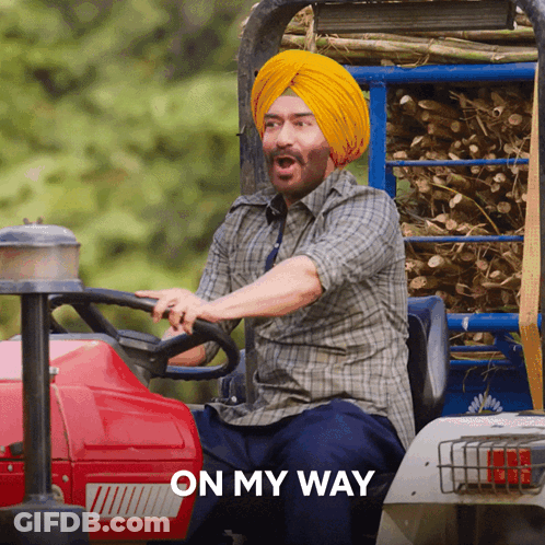 A Man In A Turban Is Driving A Tractor With The Words " On My Way " Behind Him GIF