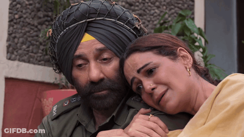 A Man In A Turban Is Hugging A Woman GIF