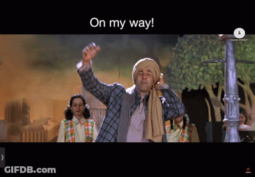A Man In A Turban Is Waving His Hand With The Words On My Way Above Him GIF