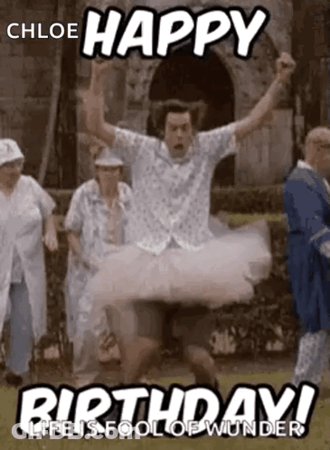 A Man In A Tutu Is Jumping In The Air While A Group Of People Are Standing Behind Him . GIF
