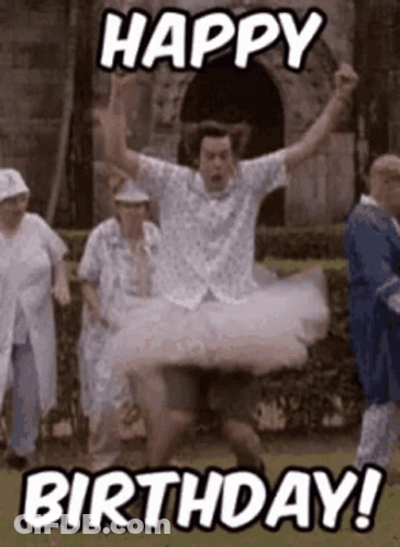 A Man In A Tutu Is Jumping In The Air While A Group Of People Are Standing Behind Him . GIF