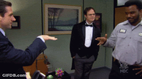 A Man In A Tuxedo And A Man In A Nbc Shirt GIF
