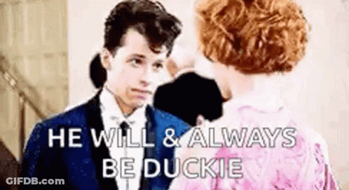 Man And Woman In Formal Attire Talking GIF
