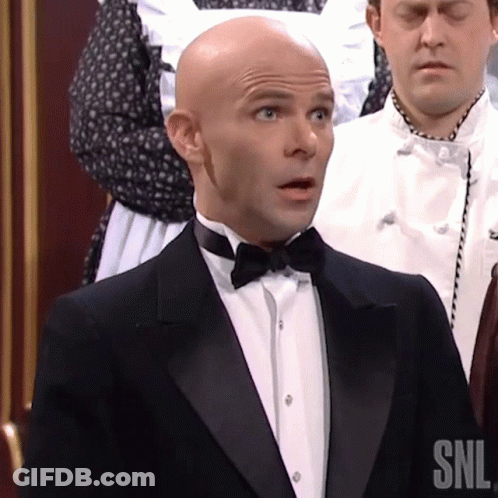 A Man In A Tuxedo And Bow Tie Has Snl Written On His Shirt GIF