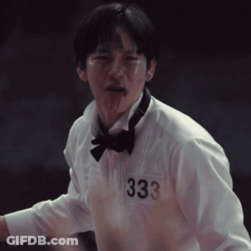 A Man In A Tuxedo And Bow Tie Has The Number 333 On His Shirt GIF