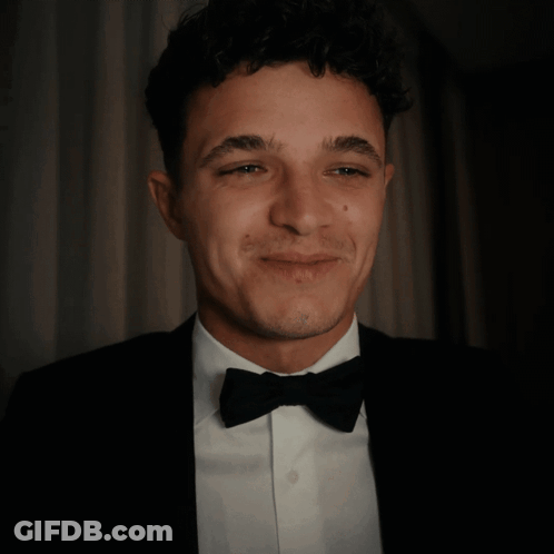 A Man In A Tuxedo And Bow Tie Is Giving A Thumbs Up GIF