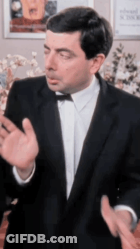 A Man In A Tuxedo And Bow Tie Is Making A Funny Face GIF