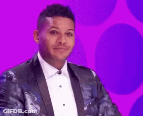 A Man In A Tuxedo And Bow Tie Is Making A Funny Face On A Purple Background . GIF