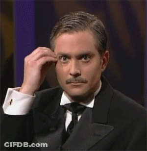 A Man In A Tuxedo And Bow Tie Is Making A Funny Face . GIF