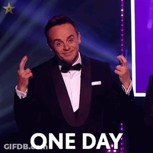 A Man In A Tuxedo And Bow Tie Is Making A Gesture With His Hands And The Words One Day Are Behind Him . GIF