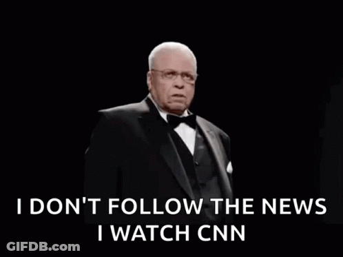 A Man In A Tuxedo And Bow Tie Is Saying I Do N't Follow The News GIF