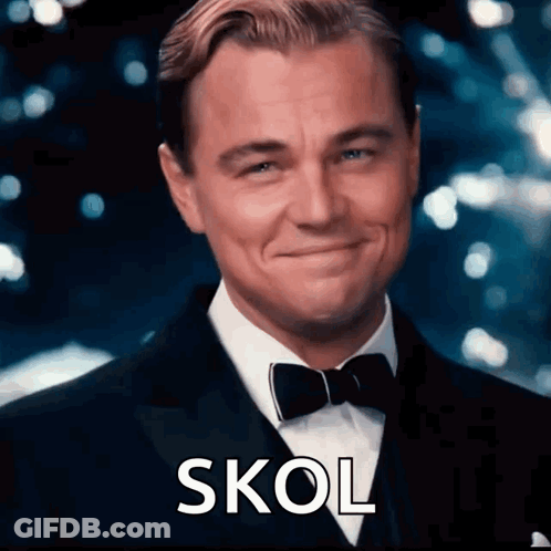 A Man In A Tuxedo And Bow Tie Is Smiling And The Word Skol Is On The Bottom Right GIF