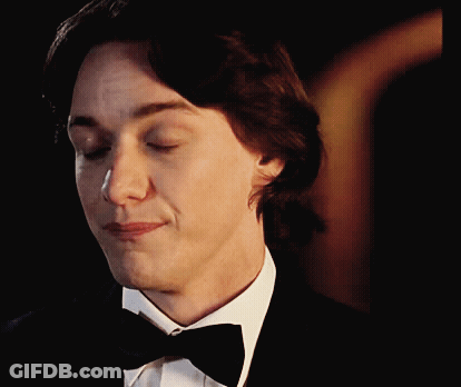 A Man In A Tuxedo And Bow Tie Is Smiling GIF