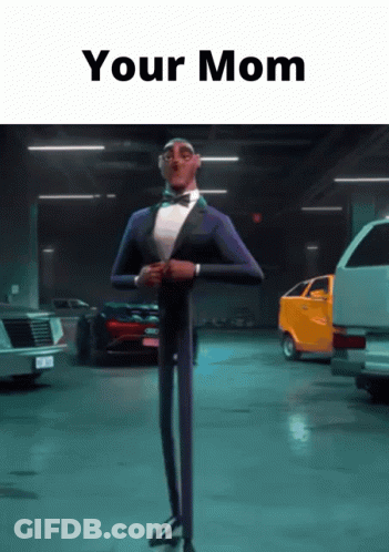 A Man In A Tuxedo And Bow Tie Is Standing In A Garage With The Words " Your Mom " Written Above Him GIF