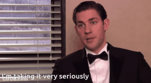 A Man In A Tuxedo And Bow Tie Is Taking It Very Seriously GIF