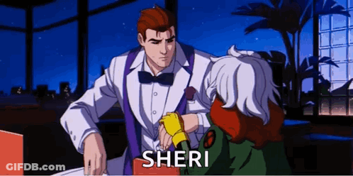 A Man In A Tuxedo And Bow Tie Is Talking To A Woman In A Green Jacket Named Sheri . GIF