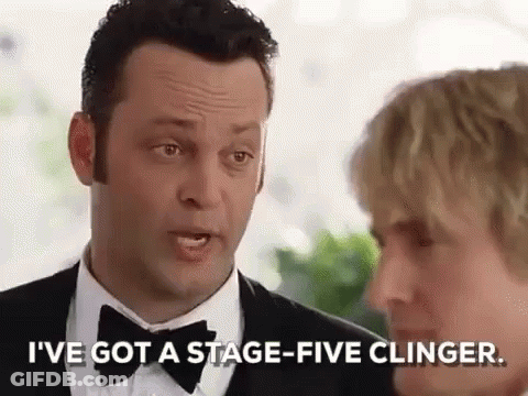 A Man In A Tuxedo And Bow Tie Is Talking To A Woman In A Suit . GIF