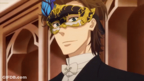 A Man In A Tuxedo And Bow Tie Is Wearing A Masquerade Mask GIF