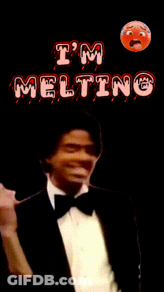 A Man In A Tuxedo And Bow Tie Stands In Front Of A Sign That Says Meg GIF
