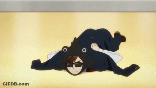 A Man In A Tuxedo And Frog Hat Is Laying On The Ground GIF