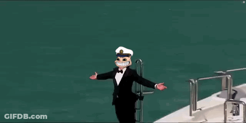 A Man In A Tuxedo And Hat Is Standing On The Side Of A Yacht . GIF