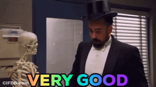 Man In Tuxedo And Top Hat Next To Skeleton Says Very Good GIF