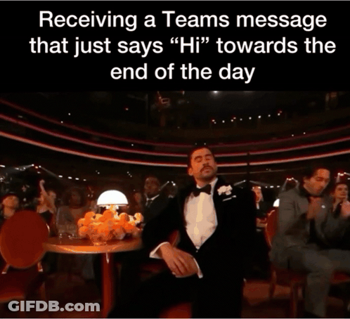 A Man In A Tuxedo Holds His Hand To His Face In Front Of A Crowd GIF