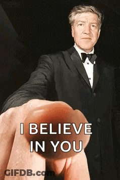 A Man In A Tuxedo Is Being Held Up By A Finger That Says I Believe In You GIF
