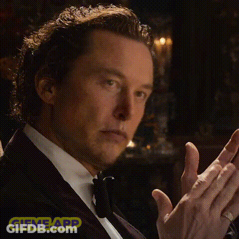 A Man In A Tuxedo Is Clapping His Hands And Wearing A Ring . GIF