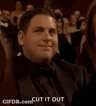 A Man In A Tuxedo Is Clapping In A Crowd At An Awards Show . GIF
