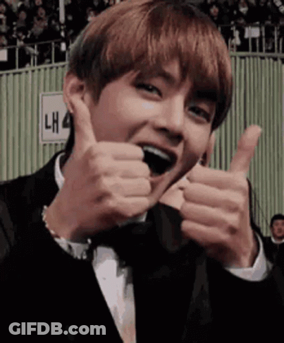 A Man In A Tuxedo Is Giving A Thumbs Up Sign . GIF